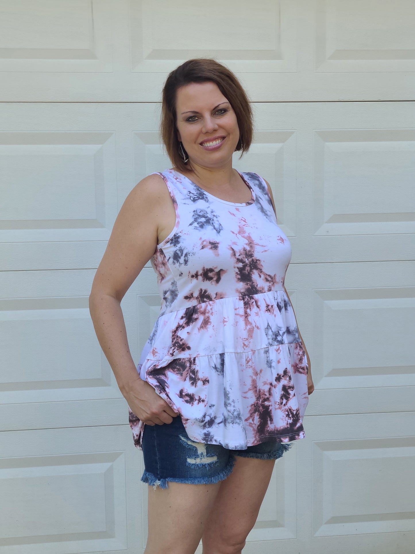 This sleeveless top is super fun and super soft, which is just what we want all of our summer tanks to be! The details include a scooped neckline, and this top is casual, comfortable and cute. Pair this top with jeans or shorts for an effortlessly chic and fun look!