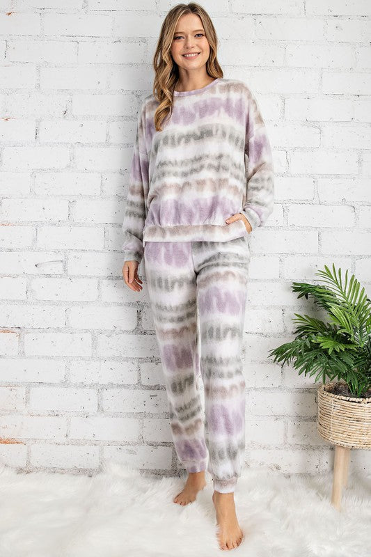 Snuggle up in your secret hideaway in the cutest lounge set! This comfortable style is essential for those cozy nights. The top features a v-neckline, long volume sleeves and drop shoulders. The top can be worn on or off the shoulder. The matching jogger lounge pants feature an elastic drawstring waistband and side pockets. The fabric is so soft and comfortable!