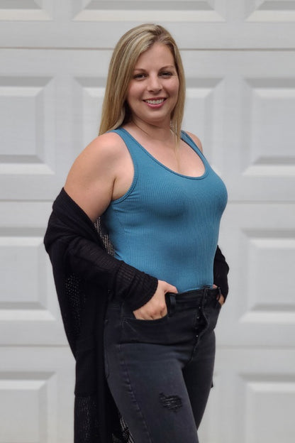 This bodysuit is so cute! It is perfect to pair with your favorite jeans, shorts or skirts. This top includes a scoop neckline, 2 snaps underneath and is so soft.
