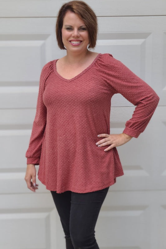 You can't miss this sweet top! Featuring a Swiss dot material, this top is a must-have. The long sleeves and v-neck style is such a sweet combination. This is the perfect top to pair with your favorite pair of jeans or dress pants for work.