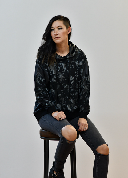 This hoodie is so different and hip. It would go perfect with your favorite pair of jeans! It features a solid faux leather trim and a drawstring detail. The fabric is soft and comfortable.