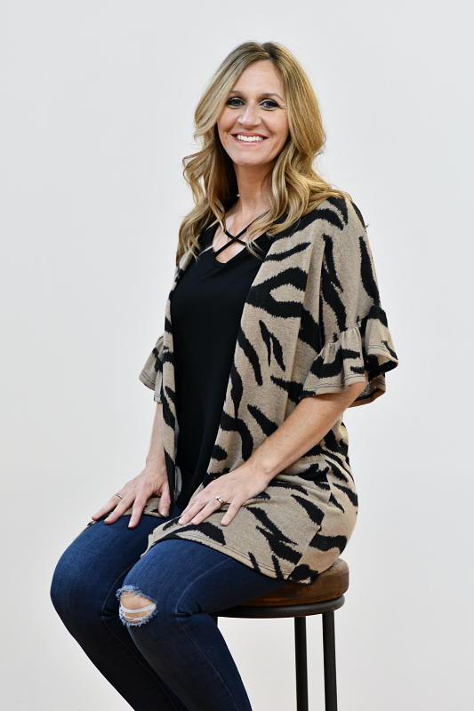 This cardigan is SO CUTE! It is perfect to throw on over your favorite t-shirt with your favorite pair of jeans! This cardigan features ruffle sleeves and is made of a lightweight material making it soft and comfortable.