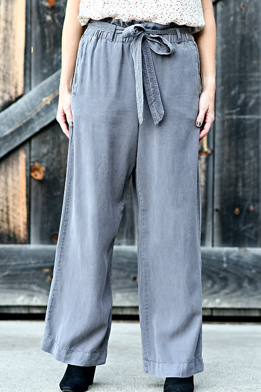 These Wide Leg Pants are the chic classy update your wardrobe has been missing! These pants have a paper bag elastic waist with belt loops, a sash belt, and back pockets.