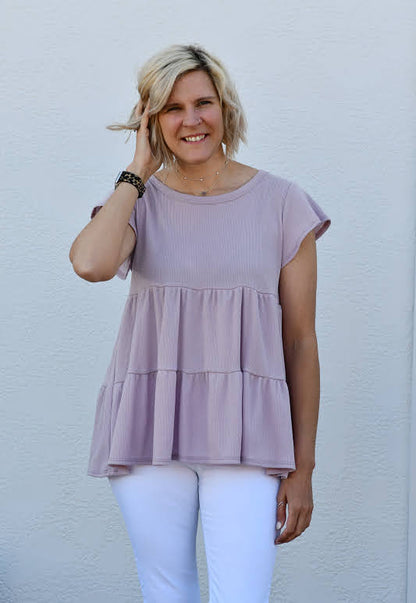 This fun top is made for a sunny spring day! Featuring a tiered bodice and lavender color, it's so effortlessly cute. This top also features a short sleeve cut, a round neckline and is so soft and comfortable. You can easily throw this on over jeans with flats!