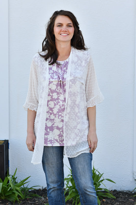 This swiss dot kimono is the perfect finishing touch to your look! It features elastic ruffle sleeves and side slits. Layer over a tank top, shorts and top off with a cute hat for a bohemian feel.